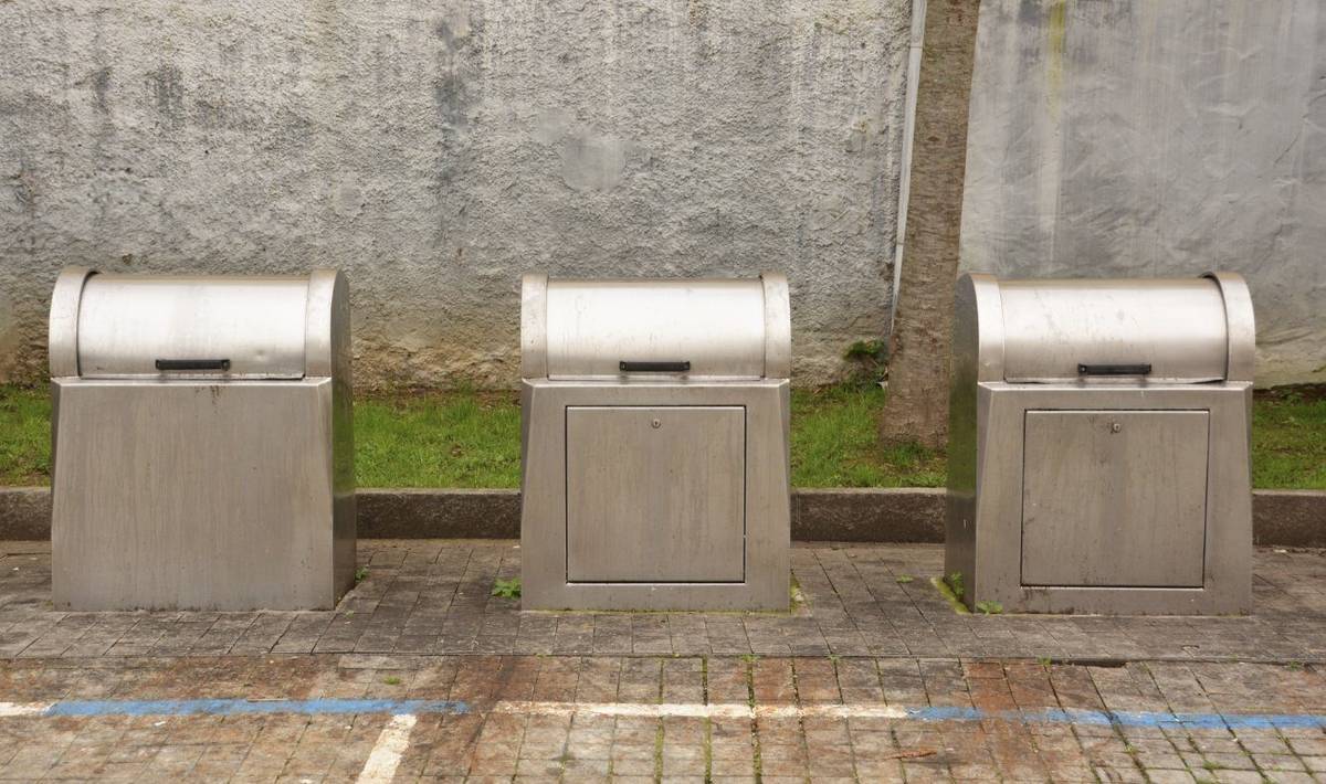 Stainless steel underground dustbins installed along a city street