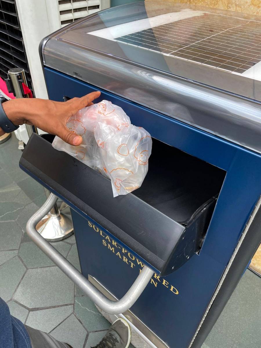 Solar-powered smart dustbin with sensor-based lid opening in use