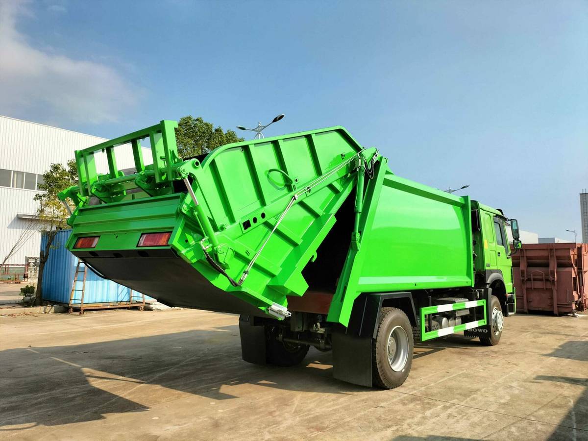 Garbage compactor rear loading system with hydraulic tailgate and bin lifter