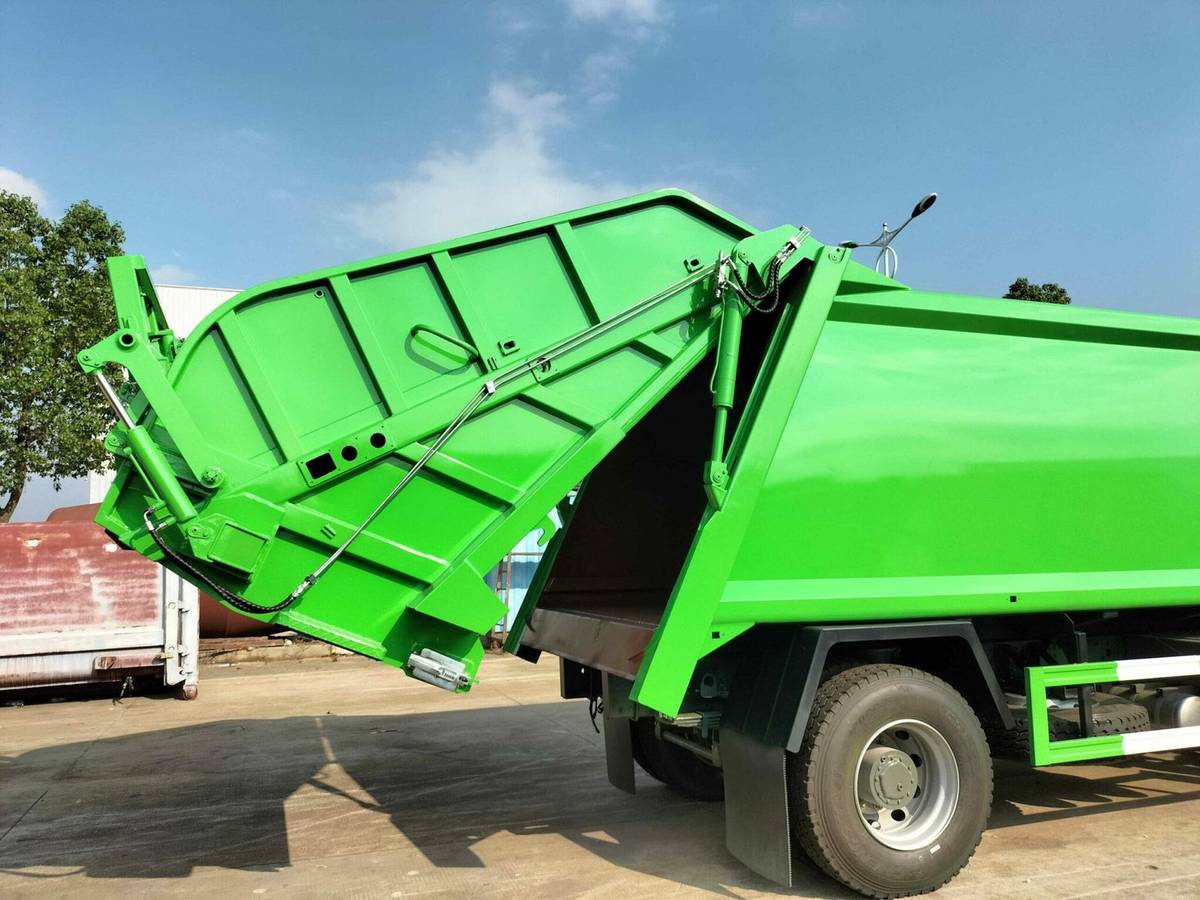 GenX SynerTech garbage compactor truck with hydraulic tailgate open